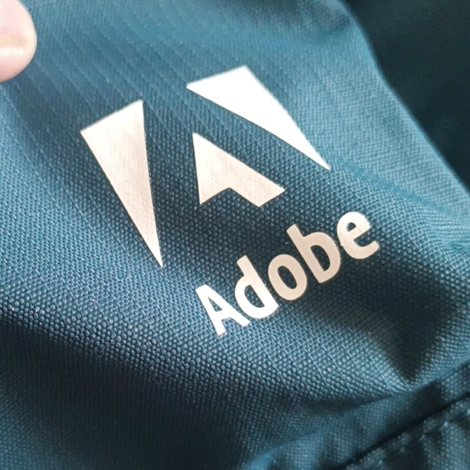 深色网眼面料上白色Adobe三角形标志热转印